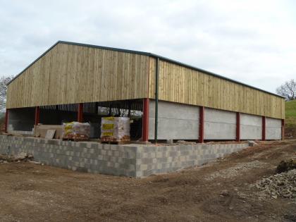 Barn from rear showing frame wood and concrete paneling