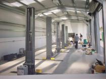 Interior of car workshop during kitting out of the steel building