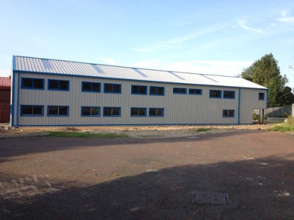 Two storey steel-built factory in grey steel with blue highlighing